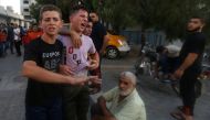 Relatives of a palestinian teenager who was killed in an Israeli air strike, react in Gaza City July 14, 2018. (REUTERS/Ibraheem Abu Mustafa)