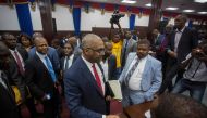 Prime Minister Jack Guy Lafontant greets supporters and opposition alike while leaving the assembly hall after announcing his resignation was accepted earlier in the day on July 14, 2018. AFP / Pierre Michel Jean
