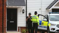 (FILES) In this file photo taken on July 4, 2018, a police officer stands guard outside Charlie Rowley's house in Amesbury, southern England, on July 4, 2018 where police reported a man and woman were found unconscious in circumstances that sparked a majo