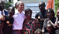 Former US President, Barak Obama (3L) poses for a picrure with his step-grandmother Sarah (C) and half-sister, Auma (2R) and some of the local youth on July 16, 2018 during the opening of the Sauti Kuu Resource Centre, founded by his half-sister, Auma Oba