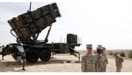 U.S. soldiers stand beside a U.S. Patriot missile system at a Turkish military base in Gaziantep, southeastern Turkey, October 10, 2014.. Reuters/Osman Orsal