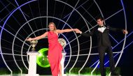 A handout picture released by AELTC and taken on July 15, 2018 shows 2018 Wimbledon Men's and Women's singles champions Serbia's Novak Djokovic (R) and Germany's Angelique Kerber dancing on stage at the Champions Dinner in central London.  AFP / AELTC / B