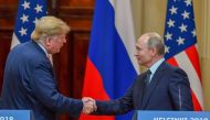 Donald Trump and Vladimir Putin shake hands before attending a joint press conference after a meeting at the Presidential Palace in Helsinki on July 16, 2018. (AFP / Yuri Kadobnov) 