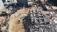  Members of the National Disaster Response Force (NDRF), along with local police, search for victims after an under construction building collapsed in the village of Shah Beri village in Greater Noida, a satellite town east of the Indian capital, in Uttar