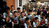 The 12 boys and their soccer coach who were rescued from a flooded cave arrive for a news conference in the northern province of Chiang Rai, Thailand, July 18, 2018. REUTERS/Soe Zeya Tun