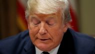 U.S. President Donald Trump reads from prepared remarks as he speaks about his summit meeting with Russia's President Vladimir Putin at the start of a meeting with members of the U.S. Congress at the White House in Washington, July 17, 2018. REUTERS/Leah 