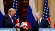 US President Donald Trump receives a football from Russian President Vladimir Putin as they hold a joint news conference after their meeting in Helsinki, Finland July 16, 2018. REUTERS/Grigory Dukor/File Photo