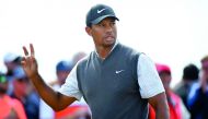 US golfer Tiger Woods acknowledges the applause after playing his shot from the 16th tee during his third round on day 3 of The 147th Open golf Championship at Carnoustie, Scotland on July 21, 2018. AFP / Andy Buchanan