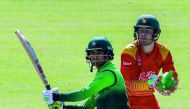 Pakistan's batsman Fakhar Zaman (L) prepares to play a shot next to Zimbabwe's wicket keeper Ryan Murray during the final cricket match of a five-match ODI series played between Pakistan and host Zimbabwe at Queens Sports Club in Bulawayo, on July 22, 201