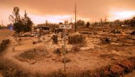 Burned out properties are seen near the Lake Keswick Estates area during the Carr fire in Redding, California on July 27, 2018. Two firefighters have died and more than 100 homes have burned as wind-whipped flames tore through the region. (AFP / JOSH EDEL
