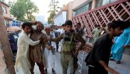 Men carry an injured man in a hospital after a suicide attack in Jalalabad, Afghanistan July 30, 2018. REUTERS/Parwiz