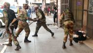 Soldiers beat a supporter of the opposition Movement for Democratic Change (MDC) outside the party's headquarters as they await election results in Harare, Zimbabwe, August 1, 2018. Reuters/Mike Hutchings
 