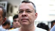In this file photo taken on July 25, 2018 US pastor Andrew Craig Brunson is escorted by Turkish plainclothes police officers to his house on in Izmir.  AFP 