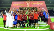 Al Rayyan players and officials celebrate with the Sheikh Jassim Cup Trophy after defeating Al Duhail at the Al Sadd Stadium yesterday. Pictures: Abdul Basit / The Peninsula 