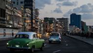 File photo of old American cars driving along Havana's Malecon on July 12, 2018.  / AFP / YAMIL LAGE