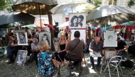 General view of artists who sketch portraits in the street on the 
