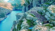 People gather in the mountains near Preikestolen (The Pullpit Rock) in Forsand near Stavanger, western Norway, on August 1, 2018, to see the movie 