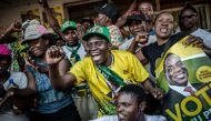 Supporters of the newly reelected Zimbabwe President Emmerson Mnangagwa, celebrate in Mbare, a district of the Zimbabwe's capital Harare on August 3, 2018. / AFP / Luis TATO 