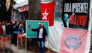 A supporter of former Brazilian President Luiz Inacio Lula da Silva takes a selfie in a camp near the Federal Police in Curitiba, Brazil August 2, 2018. The banner reads: