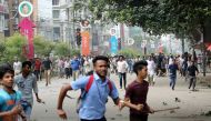 Students run back during clashes with unidentified miscreants while protesting over recent traffic accidents that killed a boy and a girl, in Dhaka, Bangladesh, August 4, 2018. (REUTERS/Mohammad Ponir Hossain)