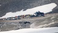 Accident investigators and rescue personnel work at the wreckage of a Junkers JU52 aircraft in Flims on August 5, 2018, after it crashed into Piz Segnas, a 3,000-metre (10,000-foot) peak in eastern Switzerland on August 4. AFP / Fabrice Coffrini
 