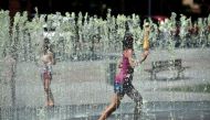 Children cool off in a fountain in Albi, southern France, on August 5, 2018, as a heatwave in Europe continues. AFP / Remy Gabalda 
