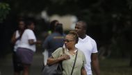 Bystanders watch as Chicago Police officers and detectives investigate a shooting where multiple people were shot on Sunday, August 5, 2018 in Chicago, Illinois. Joshua Lott/Getty Images/AFP