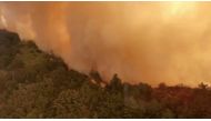 Aerial view of Trabuco Canyon as a tanker aircraft dumps load onto Holy Fire, Near Santiago Peak, California, US, August 6, 2018 in this still image taken from a video obtained from social media. TWITTER / @ZULUJUMPER/via REUTERS