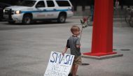 Four-year-old Leo Griffin leaves a protest against the alt-right movement held to mourn the victims of a rally held a day before in Charlottesville on August 13, 2017 in Chicago (Scott Olson/Getty Images/AFP) 
