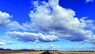 This photo taken on August 7, 2018 shows a road dividing two dry farm paddocks in the drought-hit area of Quirindi in New South Wales. AFP / Saeed Khan  