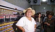 This undated picture released by North Korea's official Korean Central News Agency on August 8, 2018 via KNS shows North Korean leader Kim Jong Un (L) inspecting the Kumsanpho Fish Pickling Factory with his wife Ri Sol Ju (back C) in South Hwanghae Provin