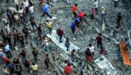 People inspect the debris of Said Al-Mashal Foundation for Arts and Culture building after Israeli forces conducted airstrikes with at least ten rockets targeted the cultural center, in western part of Gaza City, Gaza on August 09, 2018. (Ali Jadallah/Ana