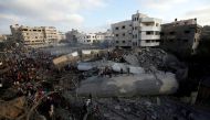 Palestinians gather around a building after it was bombed by an Israeli aircraft, in Gaza City August 9, 2018. REUTERS/Mohammed Salem 