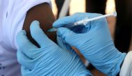 File photo of a World Health Organization (WHO) worker administers a vaccination during the launch of a campaign aimed at beating an outbreak of Ebola in the port city of Mbandaka, Democratic Republic of Congo May 21, 2018. REUTERS/Kenny Katombe/File Phot