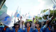 South Korean labour union members wave the unification flags as North Korean workers arrive at a hotel in Seoul, South Korea, August 10, 2018. Reuters/Kim Hong-Ji 