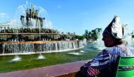 An elderly woman rests by a fountain in the All-Russia Exhibition Centre (VDNKh), a trade show and amusement park, with temperatures at around 28 degrees Celcius in Moscow on August 10, 2018. AFP / Kirill Kudryavtsev 