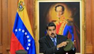 Handout picture released by the Venezuelan presidency showing Venezuelan President Nicolas Maduro speaking during the broadcasting of a television programme, at the Miraflores presidential palace in Caracas on August 7, 2018. AFP PHOTO / PRESIDENCIA VENEZ