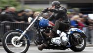 A biker rides his Harley-Davidson during a parade at the 