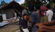 Residents pull down an earthquake damaged house in Kayangan, North lombok, Indonesia August 12, 2018. Antara Foto/Zabur Karuru/ via REUTERS