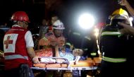 Rescuers carry a patient on a stretcher after a fire broke out at Yangon General Hospital, in Yangon, Myanmar, August 13, 2018. Reuters/Ann Wang