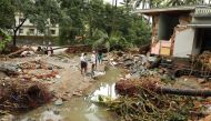 In this file photo taken on August 10, 2018 residents look at houses destroyed by flood waters at Kannappankundu in Kozhikode, in the Indian state of Kerala on August 10, 2018.  AFP 