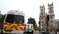 Police officers stand at a cordon after a car crashed outside the Houses of Parliament in Westminster, London, Britain, August 14, 2018. REUTERS/Hannah McKay