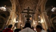 Members of the church hold a cross during a mass at the Santiago cathedral, in Santiago, Chile July 25, 2018. Reuters/Ivan Alvarado 