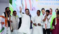 Congress party president Rahul Gandhi (C) waves to supporters as he arrives to address a public meeting at Saroornagar Stadium in Hyderabad on August 14, 2018. Gandhi is on a two-day visit to the capital city of Southern Indian State of Telangana. AFP / N
