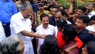 Kerala Chief Minister Pinarayi Vijayan (L) along with opposition leader Ramesh Chennithala (2L) visit a relief camp in Chengamanadu Government Higher Secondary School (HSS) in Ernakulam district of Kochi, in the Indian state of Kerala on August 11, 2018. 