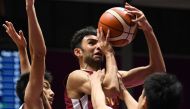Qatar’s Khaled Abdelbaset (centre) is blocked by Japan’s Shogo Tamaki (left) and Naoto Tsuji during their Group C preliminary round match of the 2018 Asian Games in Jakarta, Indonesia, yesterday.