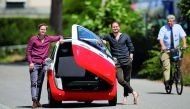 Chief Operating Officer Oliver (L) and his brother Chief Marketing Officer Merlin Ouboter of Swiss Microlino AG pose beside an electric-powered Microlino car in Kuesnacht, Switzerland July 13, 2018. Picture taken July 13, 2018. Reuters/Arnd Wiegmann