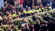 Firefighters arrive to pay their respects to the victims of the Morandi Bridge collapse, before the state funeral at the Genoa Trade Fair and Exhibition Centre in Genoa, Italy August 18, 2018. REUTERS/Stefano Rellandini 