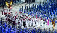 Squash star Abdulla Al Tamimi (right) carries the national flag as Qatari contingent parades during the opening ceremony of the 2018 Asian Games at the Gelora Bung Karno Stadium in Jakarta, Indonesia, yesterday.