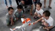 A boy touches a robot as it performs Taiji, a traditional form of Chinese martial arts, at the World Robot Conference (WRC) in Beijing, China August 17, 2018. Reuters/Jason Lee